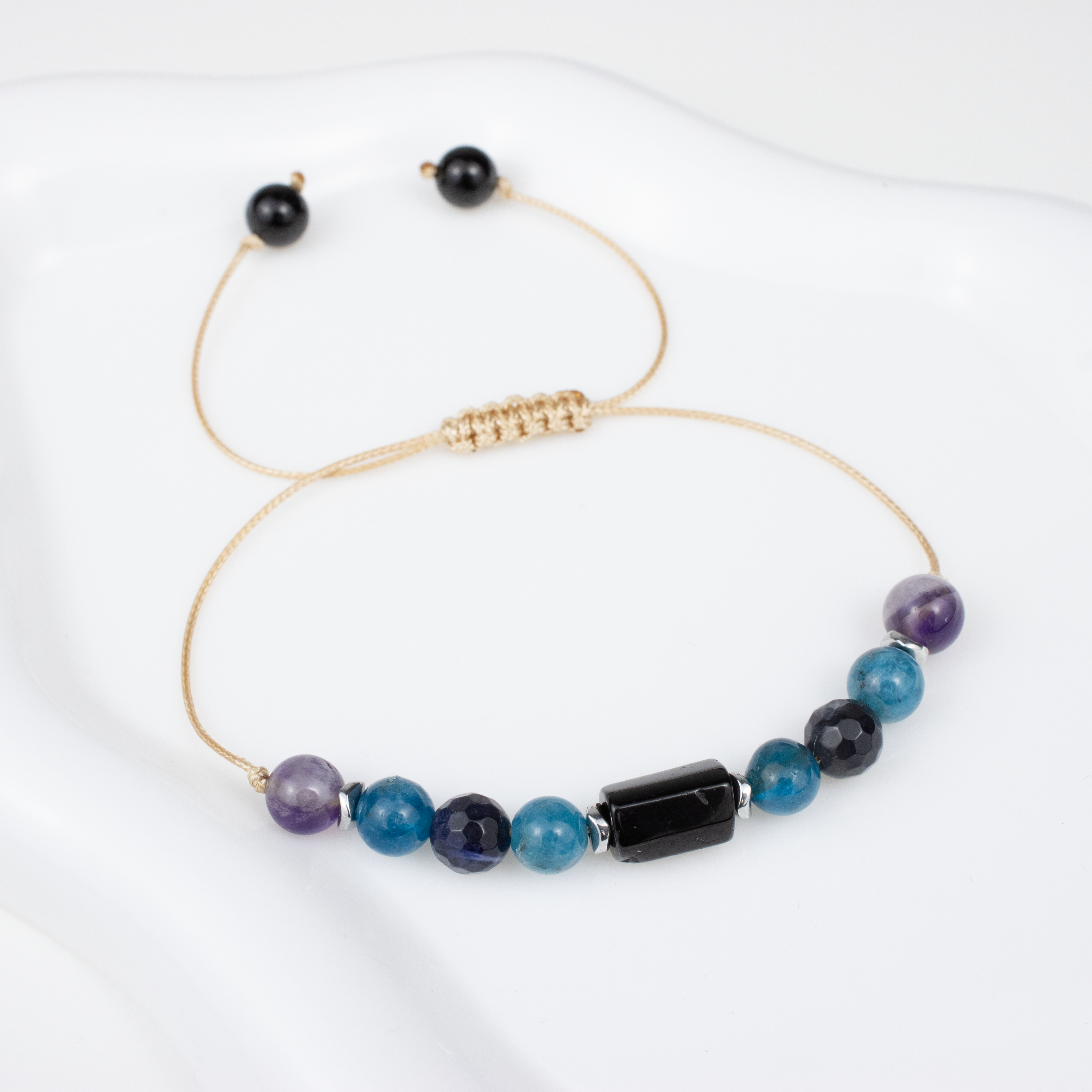 For sevens (7, 16, 25): Tourmaline, Amethyst, Apatite, Lapis Lazuli bracelet on a cord