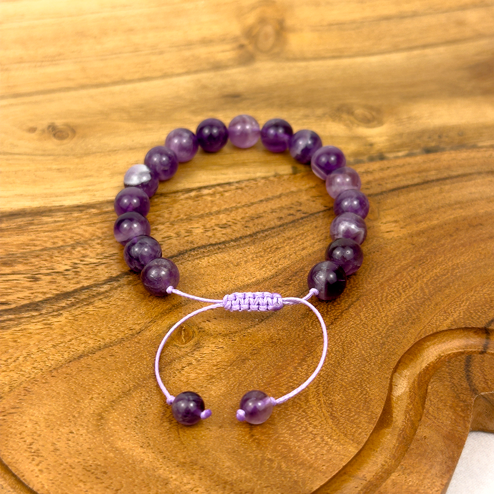 Purple beaded bracelet on a wooden surface