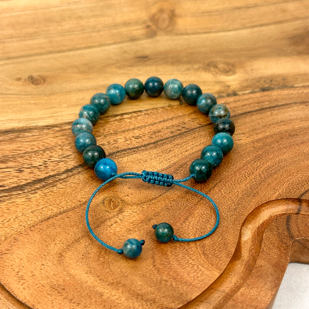 Blue beaded bracelet on a wooden surface