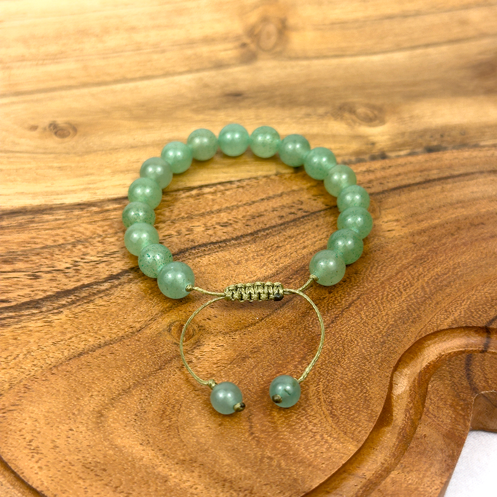 Green beaded bracelet on a wooden surface