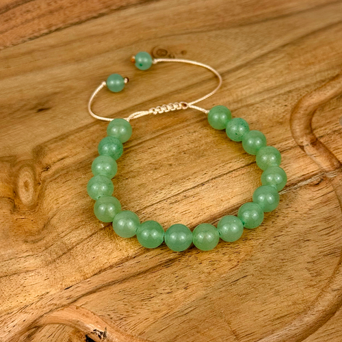 Green beaded bracelet on a wooden surface