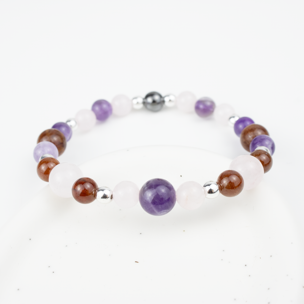 Bracelet made of natural Rose Quartz, Amethyst, and Garnet stones on elastic thread