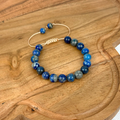 Blue beaded bracelet on a wooden surface
