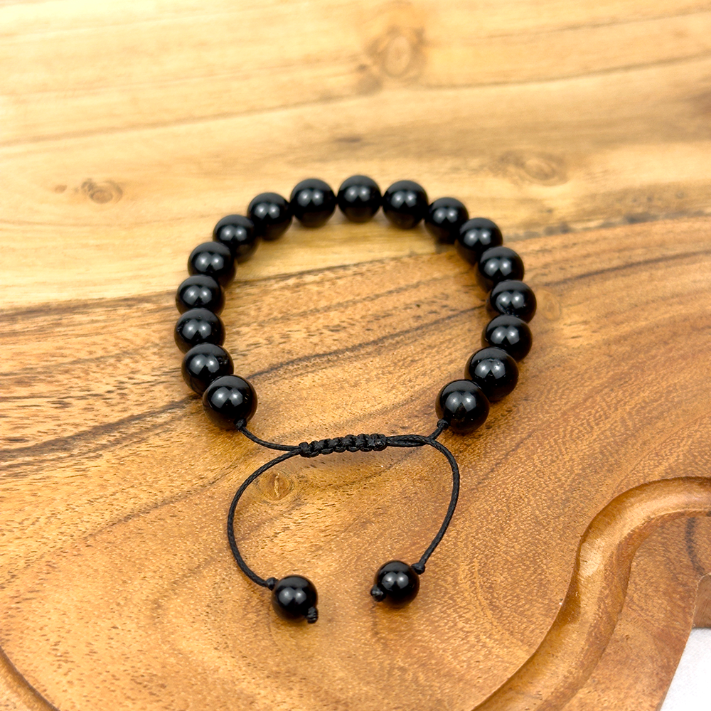 Black beaded bracelet on a wooden surface