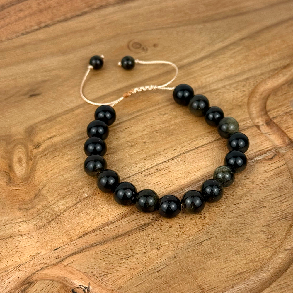 Black beaded bracelet on a wooden surface