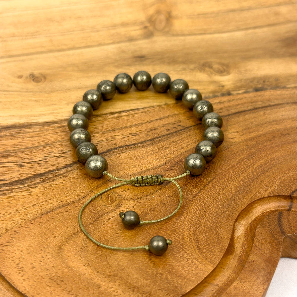 Beaded bracelet with a clasp on a wooden surface