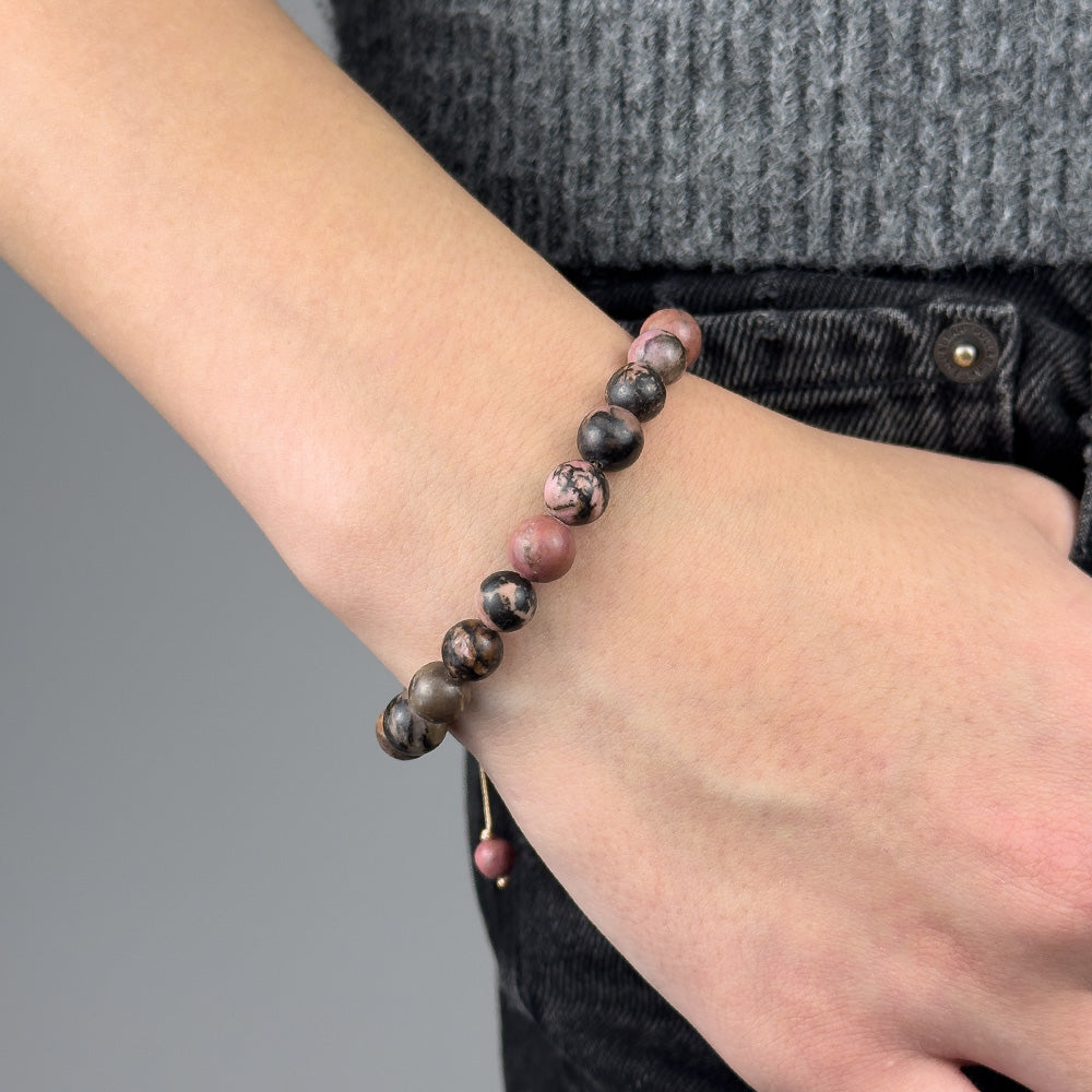 Beaded bracelet on a wrist with a gray background