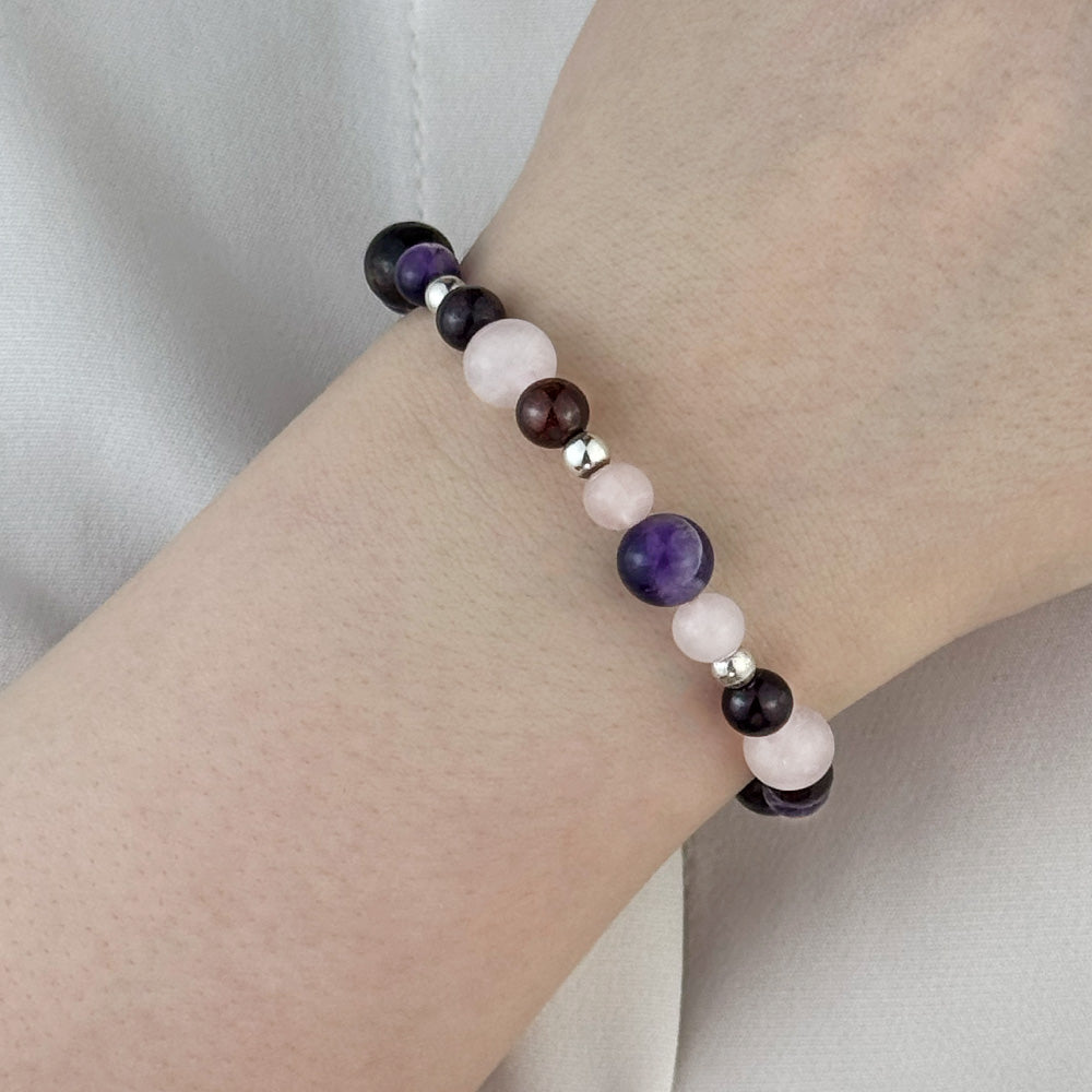 Bracelet made of natural Rose Quartz, Amethyst, and Garnet stones on elastic thread