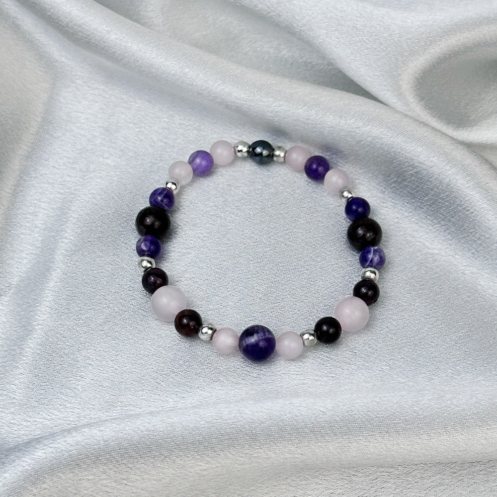 Bracelet made of natural Rose Quartz, Amethyst, and Garnet stones on elastic thread