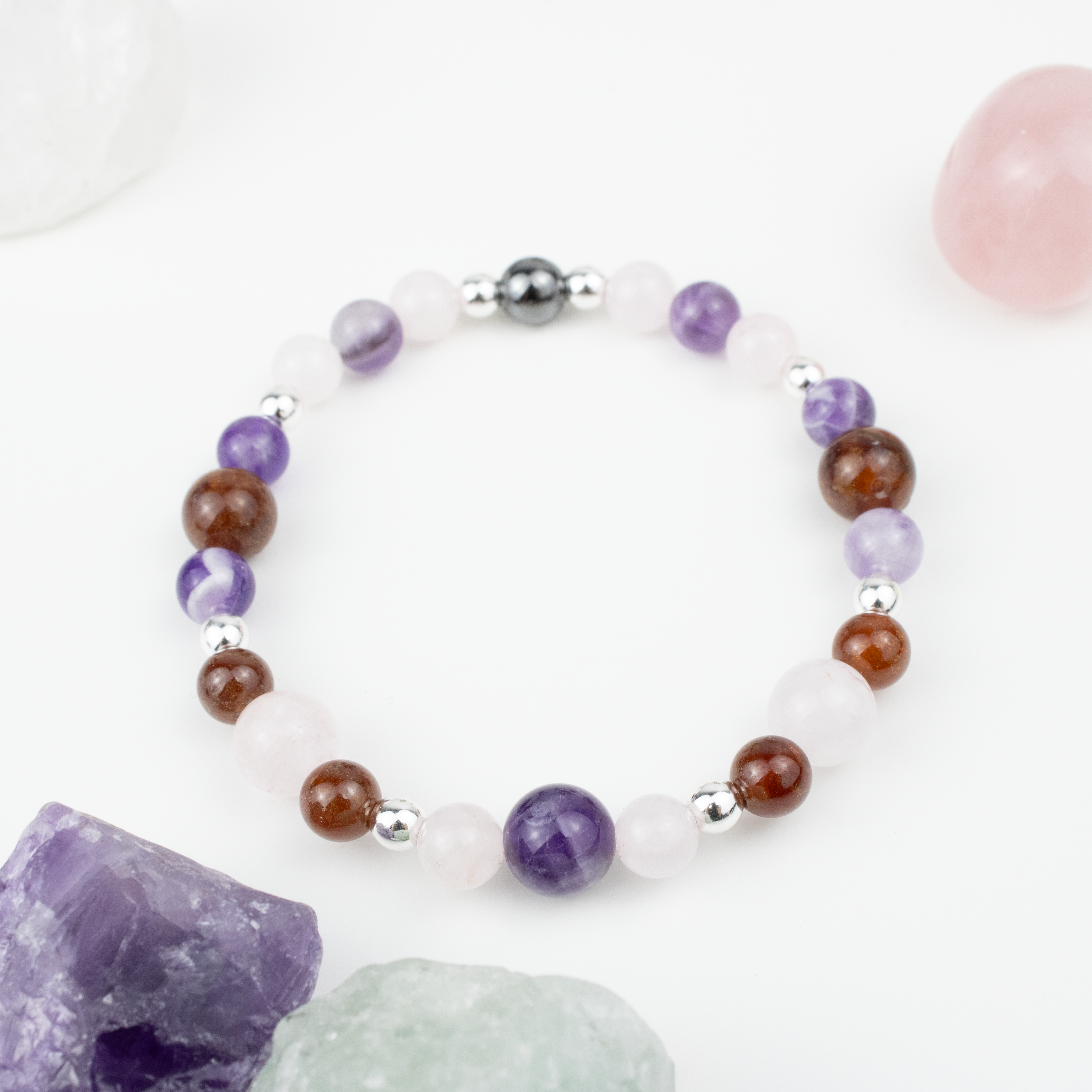 Bracelet made of natural Rose Quartz, Amethyst, and Garnet stones on elastic thread