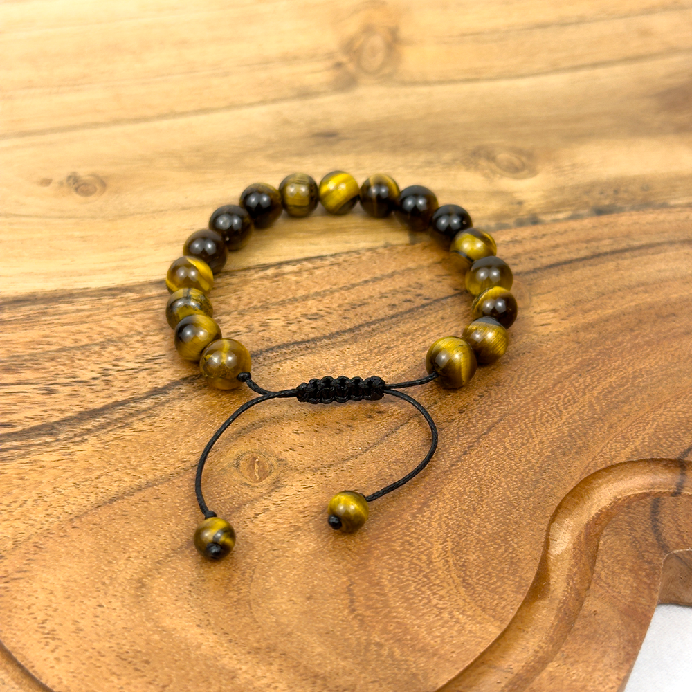 Beaded bracelet with yellow and black beads on a wooden surface