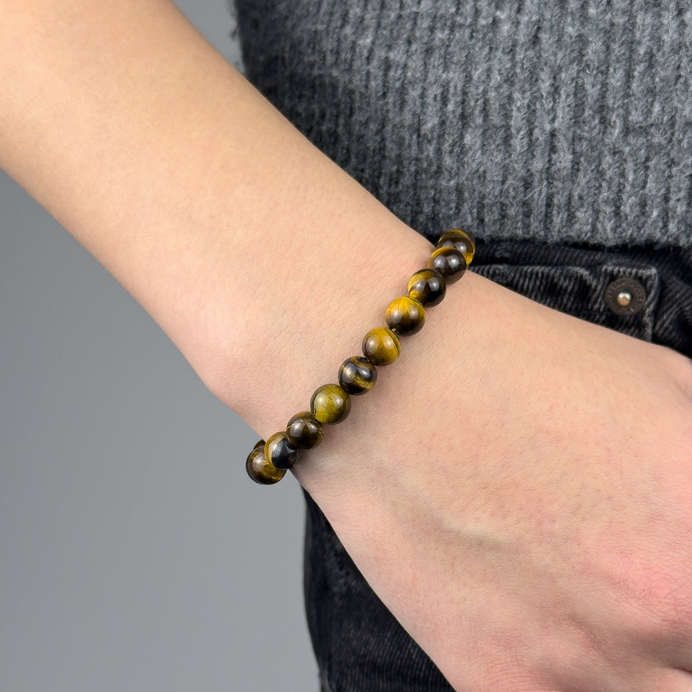 Beaded bracelet on a wrist with a gray background