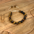 Beaded bracelet with brown and black beads on a wooden surface