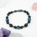 Bracelet made of natural Tourmaline, Lava Stone, and Tiger’s Eye stones on elastic thread