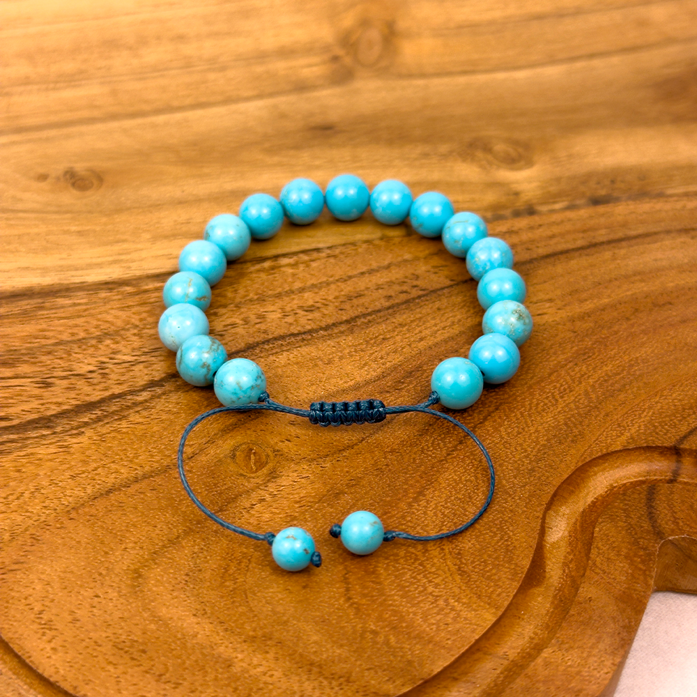 Turquoise beaded bracelet on a wooden surface